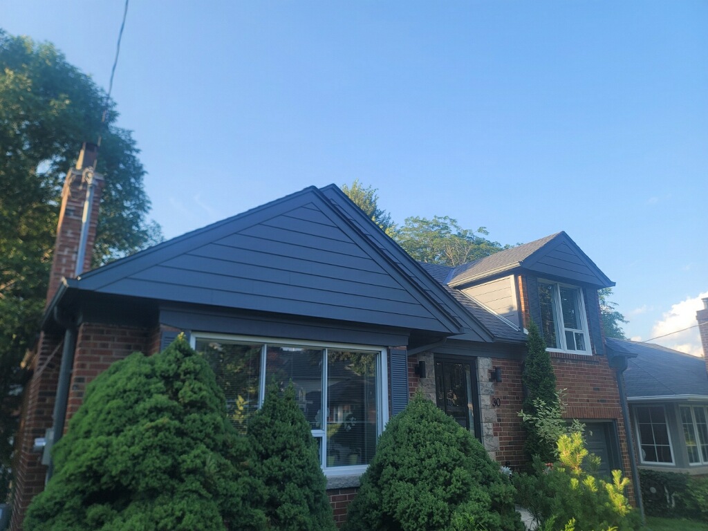 Deteriorated wood siding on the gable of a home in The Kingsway, Toronto