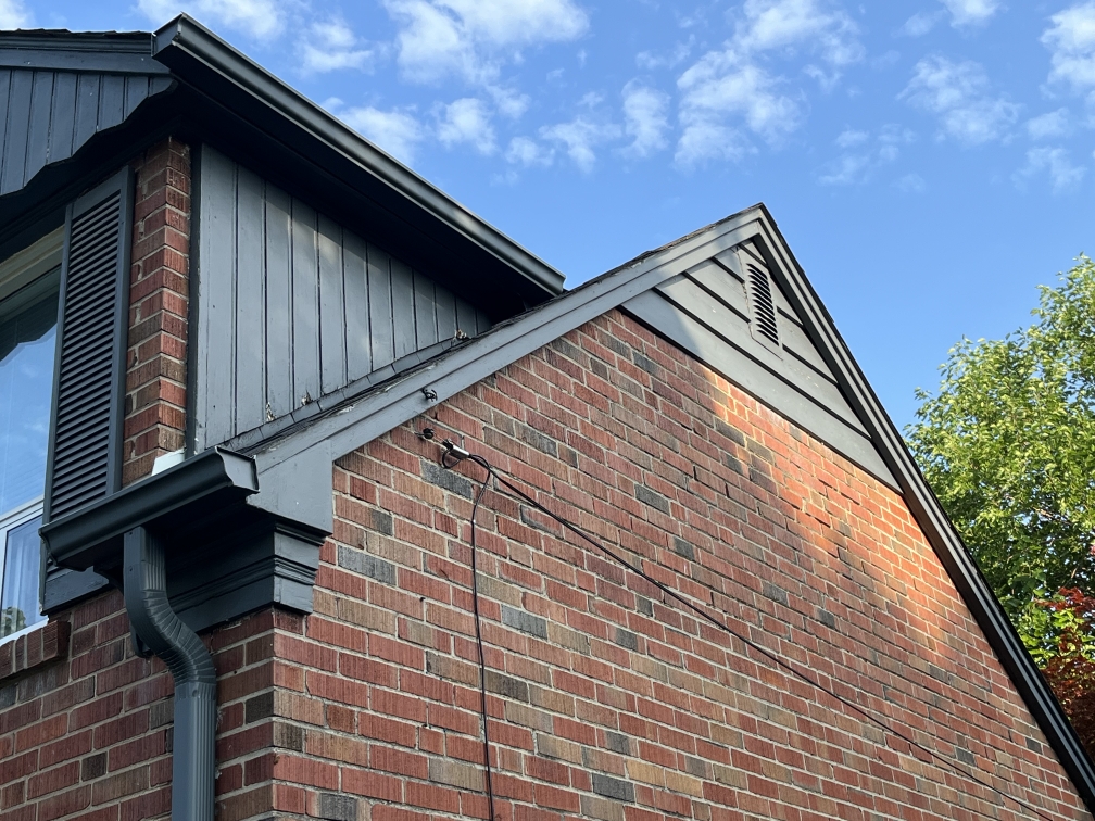 Original vertical wood siding before replacement on a home in The Kingsway, Toronto